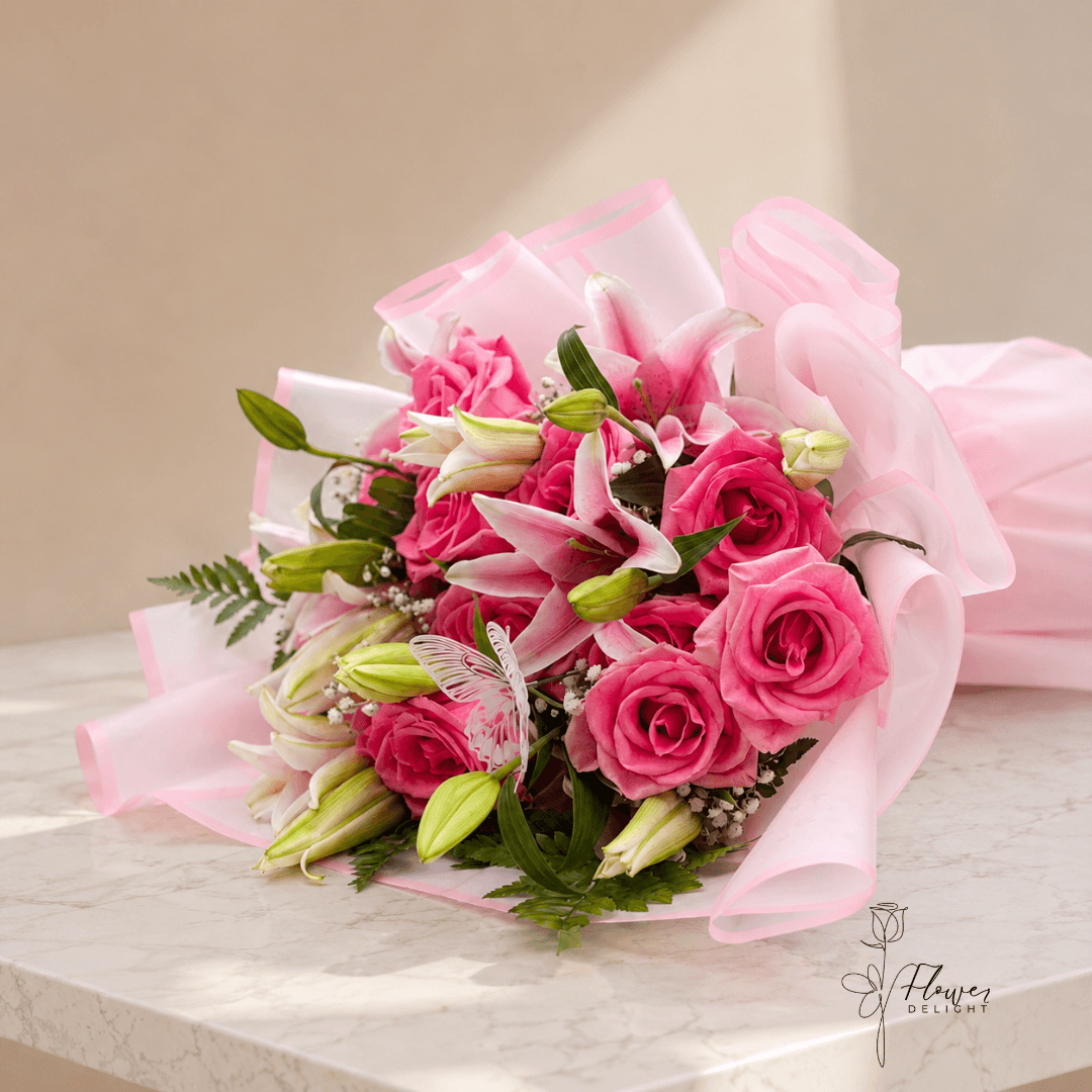 12 Pink Roses and Pink Lilies with Clear Pink Wrapping by Flower Delight