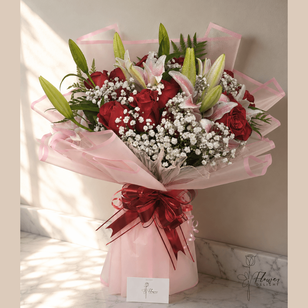 12 Red Roses and Pink Lilies with Clear Pink Wrapping by Flower Delight