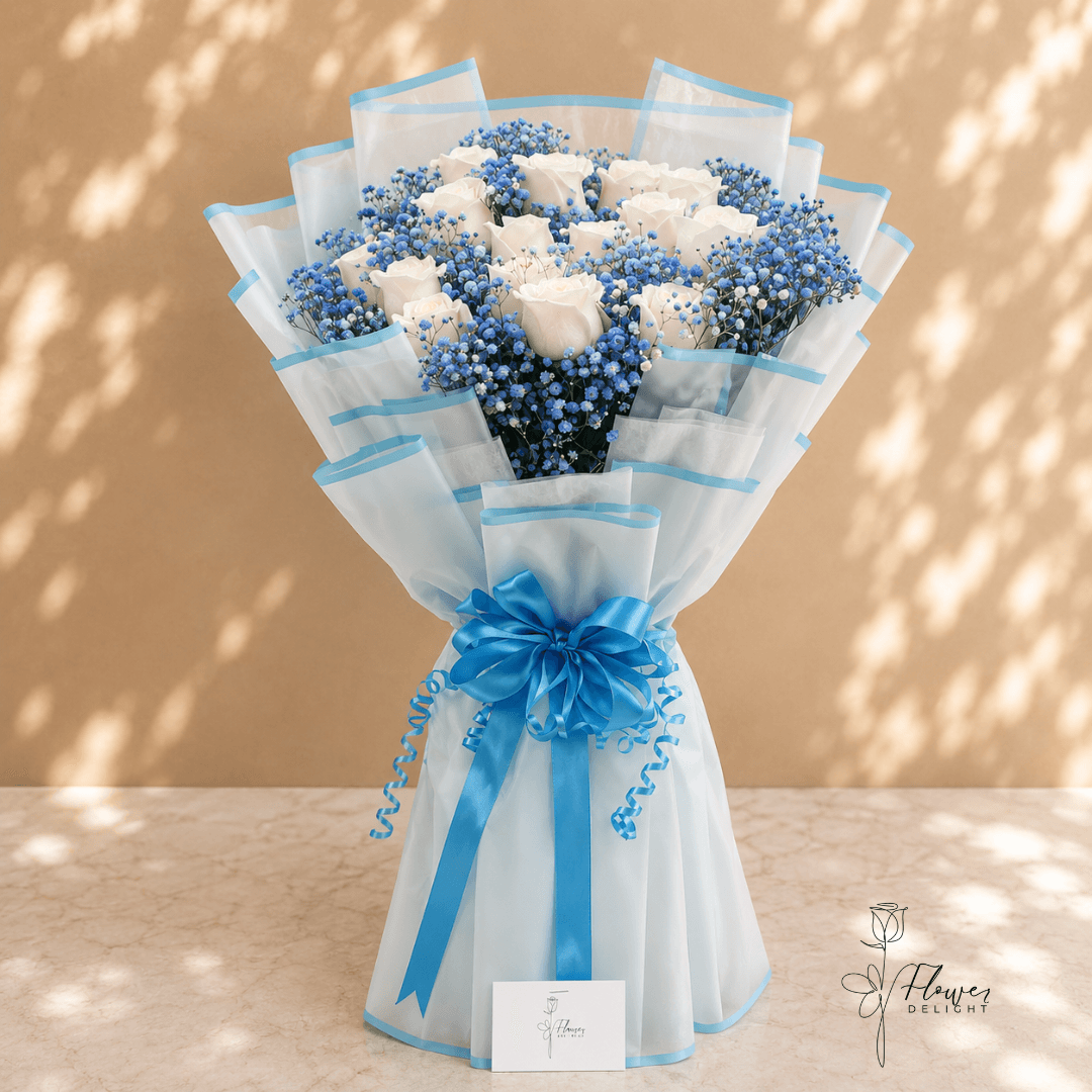 White roses with blue wrapping by Flower Delight