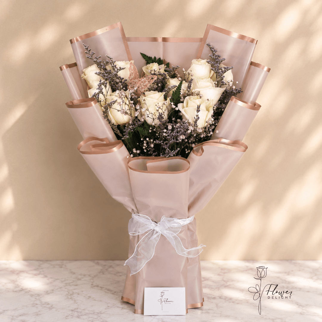 12 White Roses with Purple Wrapping by Flower Delight