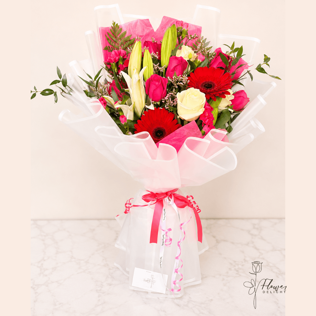 Roses, Gerbera and Lilies Mixed with Clear White Wrapping by Flower Delight