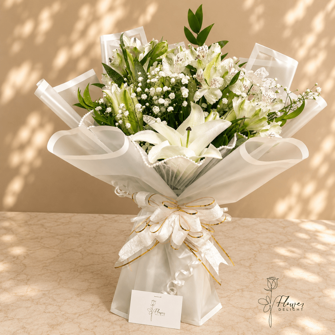 White Lily Bouquet with Clear White Wrapping and Beaded Skirt by Flower Delight